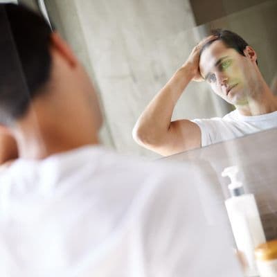 Esos bultos dolorosos al peinarte: Por qué te salen espinillas en el cuero cabelludo